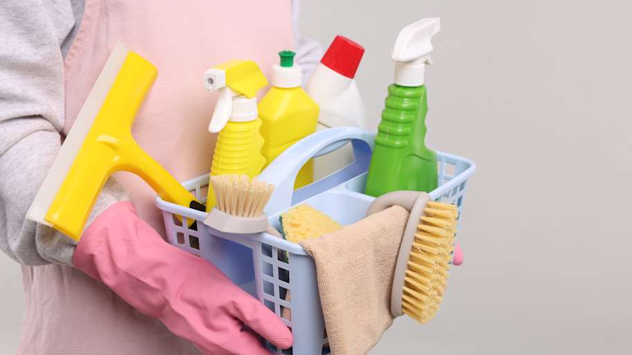 Woman with basket of cleaning supplies